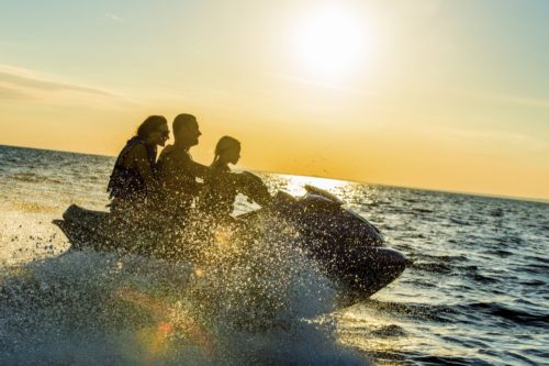 family on jet ski in ocean