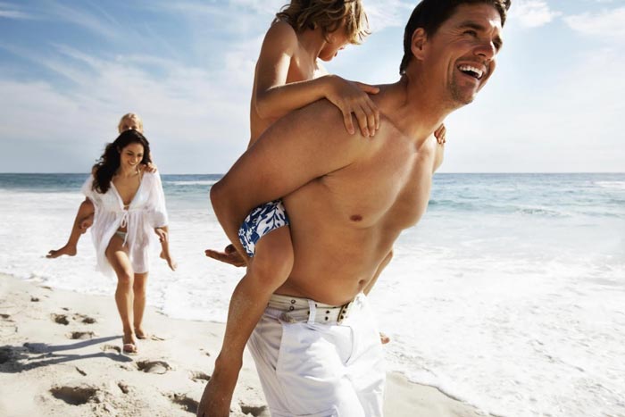 family having fun on beach